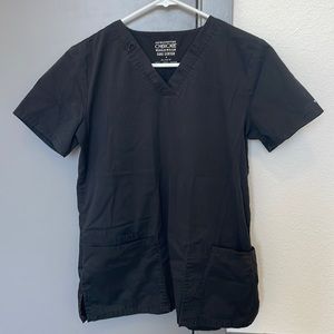 Cherokee black scrub top. Bleach stain on L front pocket, shown